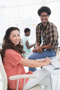 Young creative team working at desk in creative office