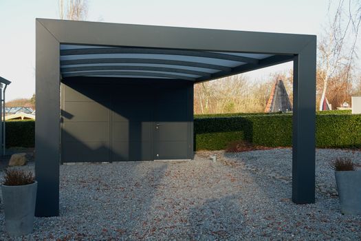Modern carport car garage parking made from black metal and glass                                       