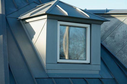 Modern design vertical roof window with white light metal covering                                                       