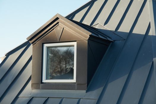 Modern design vertical roof window with black light metal covering                                                       