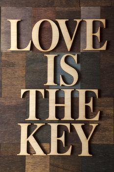 ''love is the key'' on wooden background