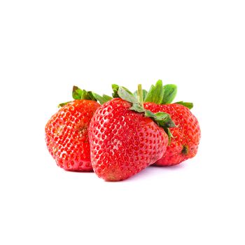 Three strawberries with leaves on a white background
