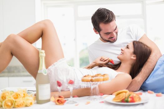 Young couple having a romantic breakfast at home in the kitchen