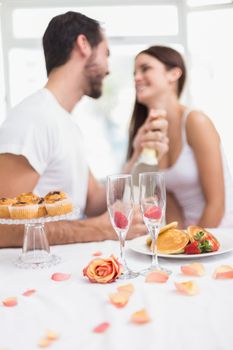 Young couple having a romantic breakfast at home in the kitchen