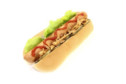 Hot dog with cucumber, sausages, salad, fried onions and ketchup