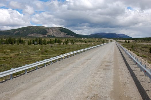 Gravel road Kolyma state highway at outback of Russia,Yakutia and Magadan region