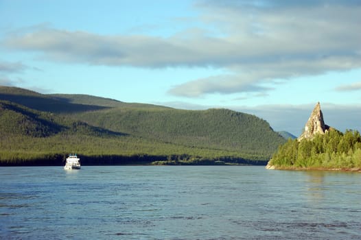 Cargo ship and rock at Kolyma river Russia outback