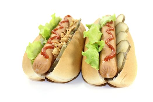 Hot dogs with cucumber, sausage, fried onions and ketchup