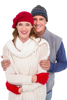 Happy couple in warm clothing on white background