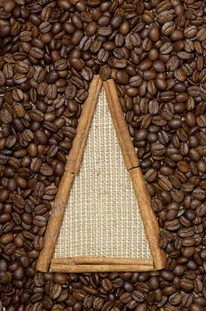 
Christmas tree made of cinnamon sticks on coffee and sack background