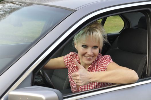 woman driving a gray car