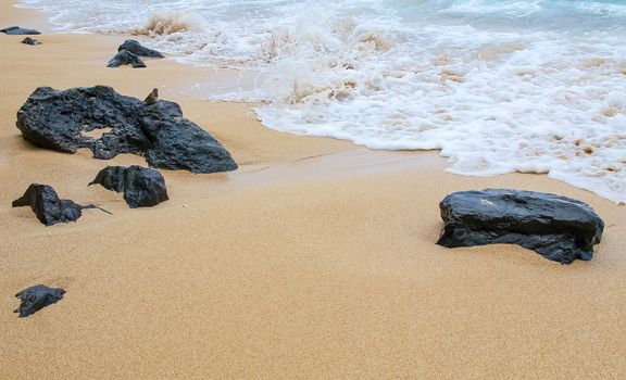 Volcanic rocks on the shore of the Pacific Ocean in Maui, Hawaii