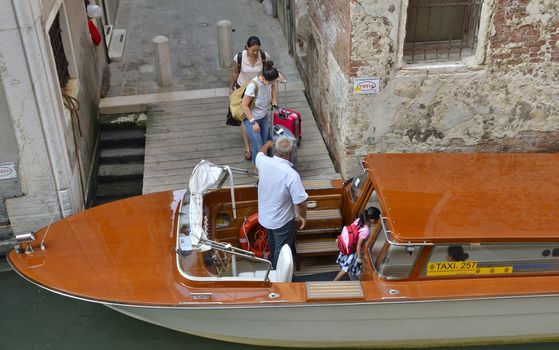 Tourists getting into a taxi in Venice, Italy