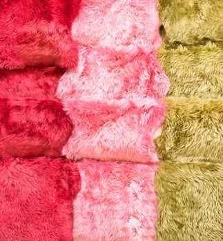 Colorful sheepskin rugs as a background