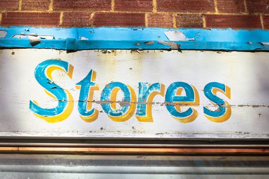 Sign for stores on a weathered wooden board