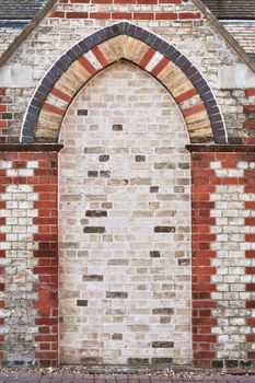 An arch shaped alcove in a brick wall