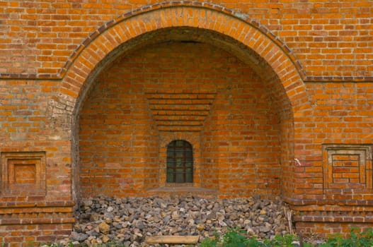 Old brick wall with window and stones