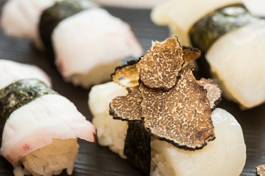 Closeup of white tuna nigiri sushi pieces with truffle