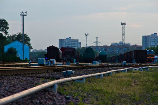 train depot with trains and locomotives in the summer