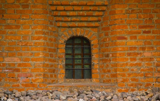 Old red brick wall with window closeup