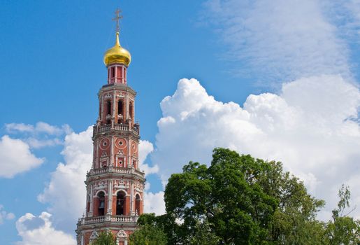 old brick bell tower among the trees