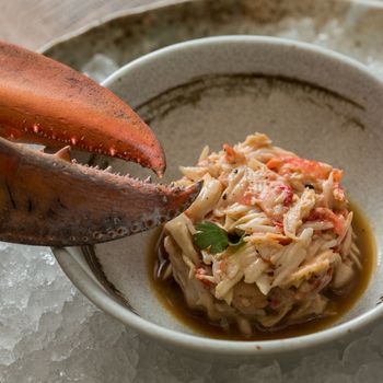 Crab meat in a dish on wood table