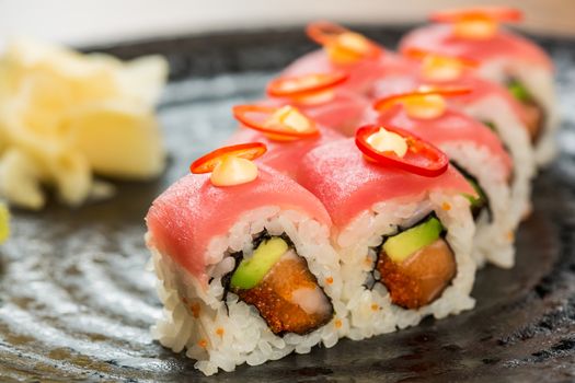 Maki Sushi. Roll with Cucumber and Cream Cheese inside. Topped with Tuna