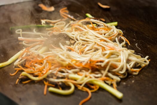 Preparing pad thai at a street hawker mobile restaurant in Bangkok, Thailand. Fried noodle. Shallow dof. 