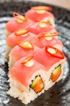 Maki Sushi. Roll with Cucumber and Cream Cheese inside. Topped with Tuna