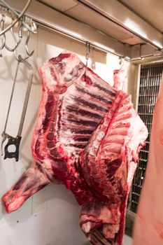 Quarters of veal and pork hanging in true Sicilian butcher