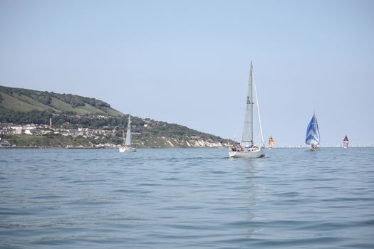 yacht sailboats sailing on a calm sunny day on the solent