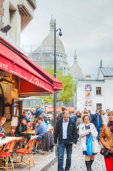 PARIS - OCTOBER 12: Crowded street on the Montmartre hill on October 12, 2014 in Paris, France. Many artists had studios or worked in or around Montmartre, including Dali, Modigliani, Monet and others.