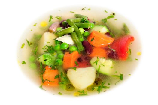Fresh vegetable soup made of green bean, carrot, potato, red bell pepper, tomato in bowl