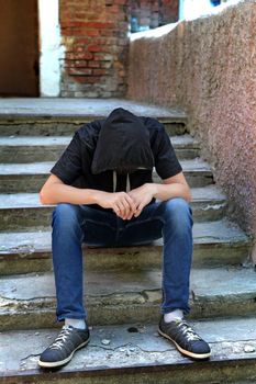 Sad Teenager on the landing steps of the Old House