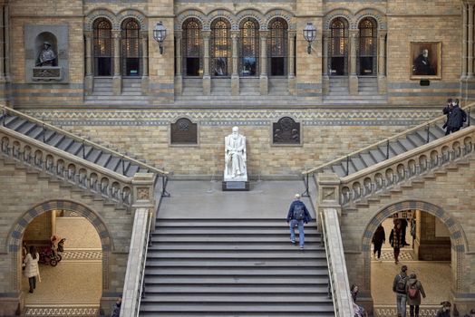 LONDON, UK - DECEMBER 11: High angle shot of staircase with statue of Charles Darwin at Natural History Museum. December 11, 2014 in London. 