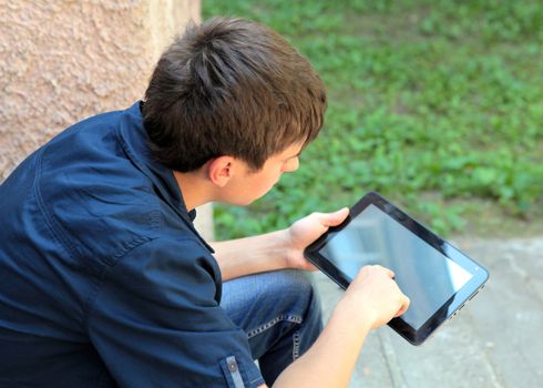 Teenager with Tablet Computer on the Street