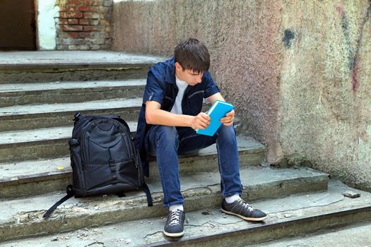 Sad Student with the Book on the landing steps