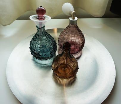 Perfume bottles made of glass, beautiful shape
located on the tray.                              