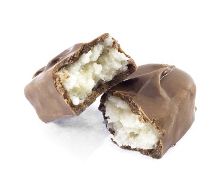 Closeup of chocolate bar with coconuts isolated on white.