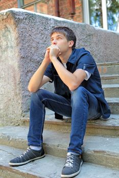 Pensive Teenager on the landing steps of the House