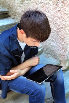 Teenager with Tablet Computer on the Street