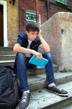 Sad Student with the Book on the landing steps