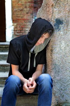 Sad Teenager on the landing steps of the Old House