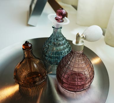 Perfume bottles made of glass, beautiful shape
located on the tray.                               