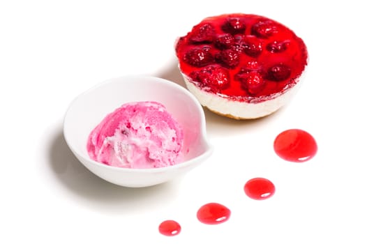 Raspberry layered cheese cake and pink ice cream ball, isolated on white