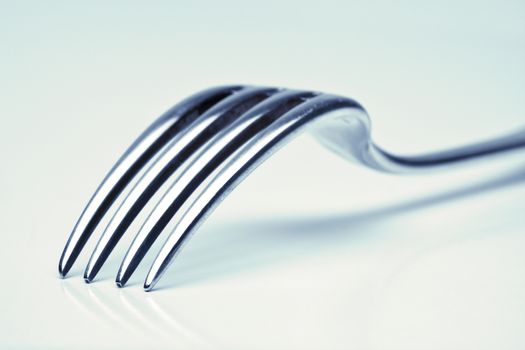 silverware - extreme closeup of a fork with blue tint