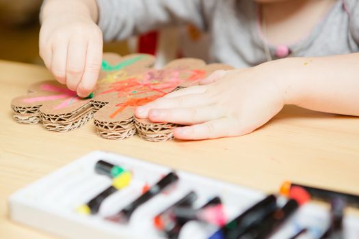 Little female baby painting with colorful paints. selective focus