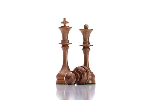 chess game - black pawn lying under black king and queen
