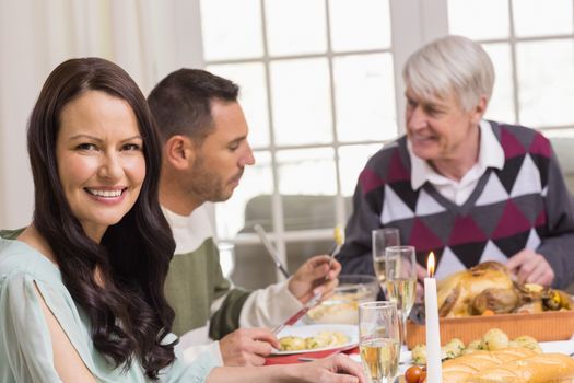 Smiling woman during christmas dinner at home in the living room