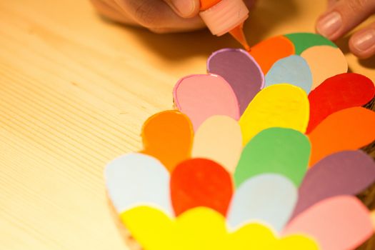 Colorful toys made of cardboard on a wooden table. Creative background